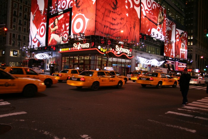 Times Square by night, with a lot of yellow taxis